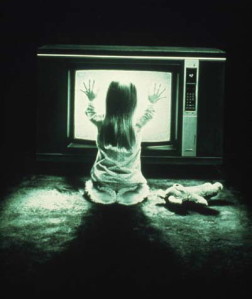Little girl in front of a TV during the night