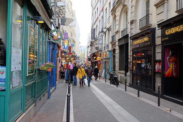 Paris, France - Circa 2019: Pedestrians walking near burned luxury